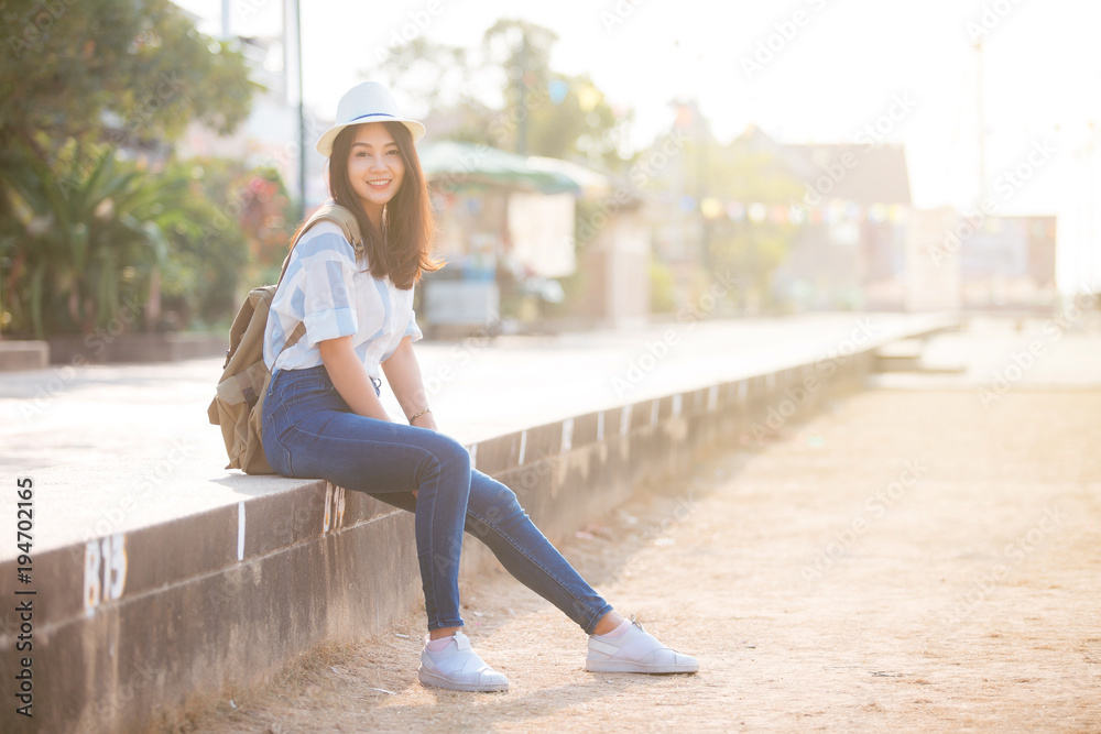 Fototapeta premium Young beautiful female traveler in the city