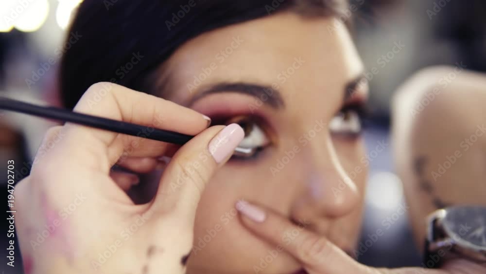 Using special angled eyeliner brush to apply black pigment on the waterline. Creating perfect smokey look. Using special angled eyeliner brush to apply black pigment on the waterline. Creating perfect smokey look.
