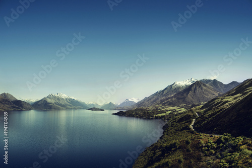 Picture of a the Lake Wakatipu and some mountains over a blue sky near Glenorchy, in New Zealand.
