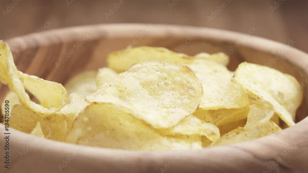 Slow motion closeup potato chip fall into bowl Slow motion closeup potato chip fall into bowl