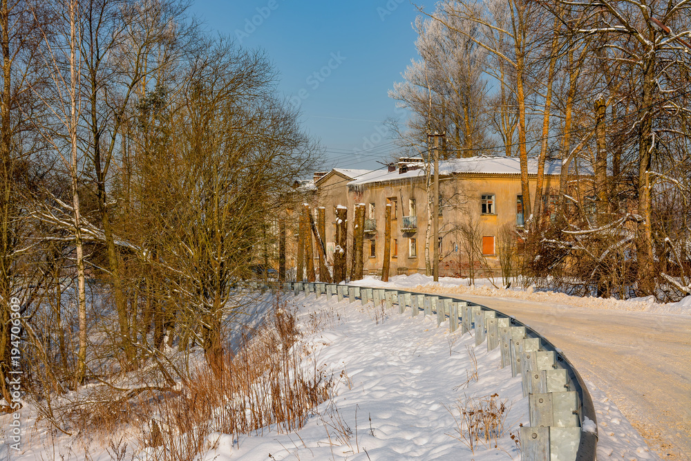 Sunny winter day in the countryside. The sign of winter-icicles