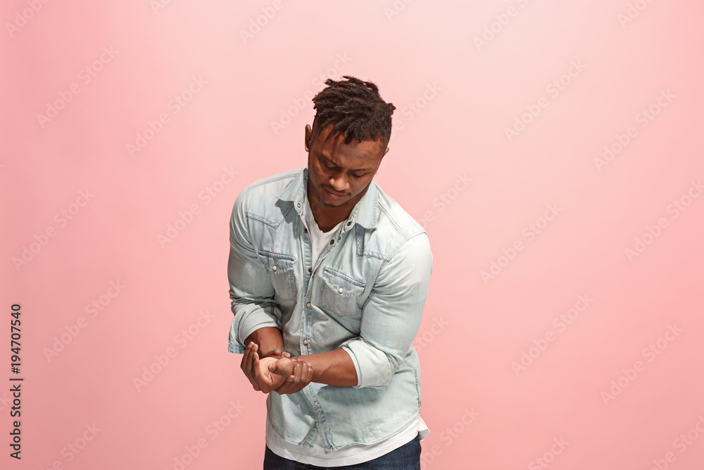 Young man overwhelmed with a pain in the hand. Young man overwhelmed with a pain in the hand.