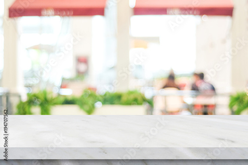 Empty white marble table over blur restaurant background, product and food display montage