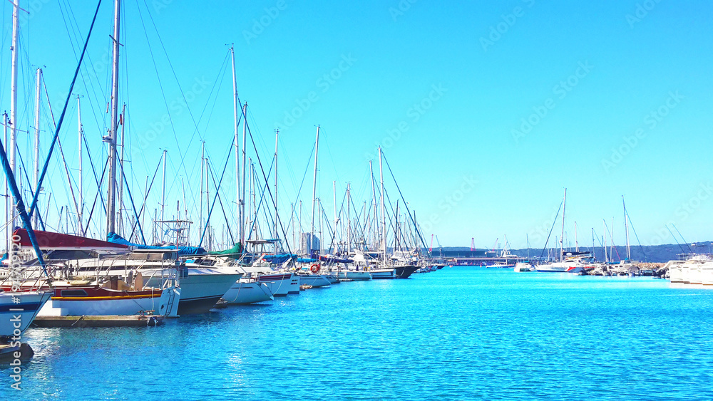 Marina setting with blue skies, sea and yachts