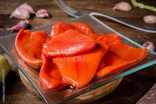 Roasted and peeled peppers on wood