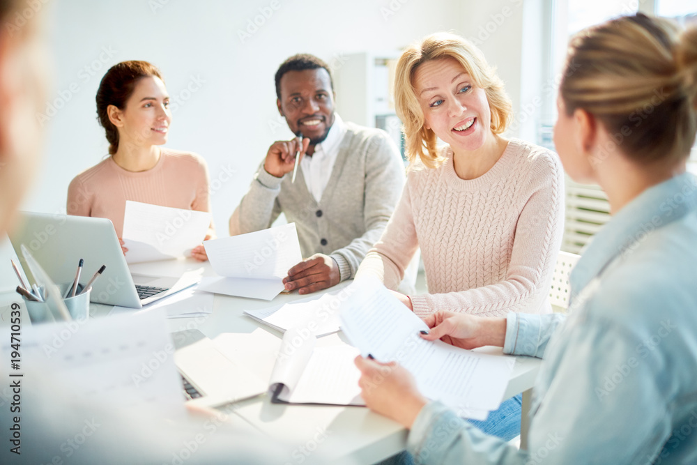 Successful female having talk to one of her subordinates at meeting in office Successful female having talk to one of her subordinates at meeting in office
