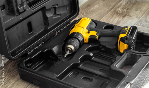 hand electric tool: a yellow screwdriver in a molded black box