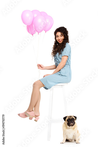 beautiful young woman with pink balloons and pug puppyisolated on white photo
