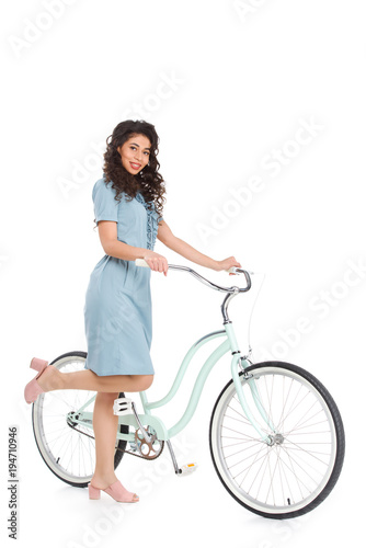 Fototapeta Naklejka Na Ścianę i Meble -  attractive young woman in dress with bicycle isolated on white