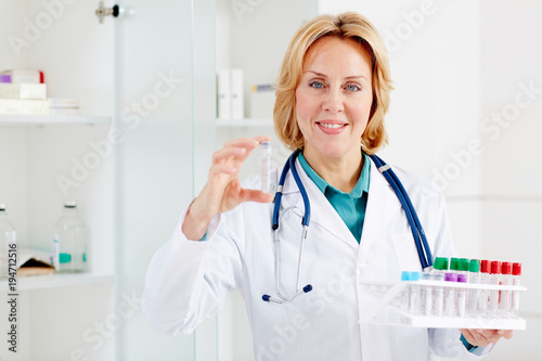 Female doctor is showing a flask in hospital