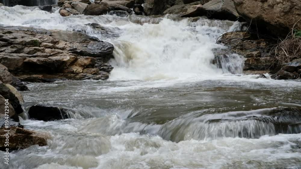 Close up.Pure fresh water waterfall in forest with black rocks. Close up.Pure fresh water waterfall in forest with black rocks.