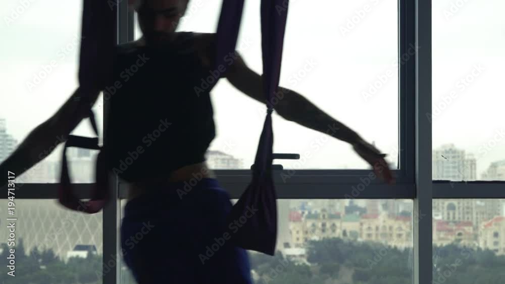 Rastafarian young man yoga teacher. Studio with city view. Rastafarian young man yoga teacher. Studio with city view.
