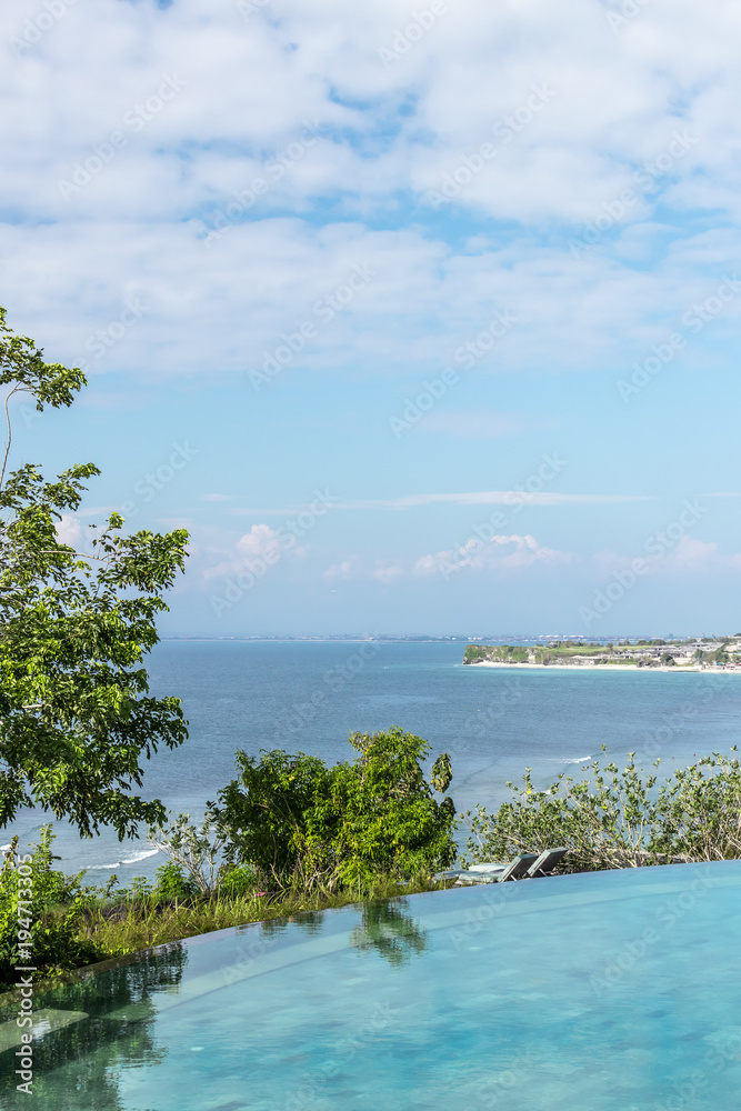 Infinity pool on the bright summer day. Bali island. Infinity pool on the bright summer day. Bali island.