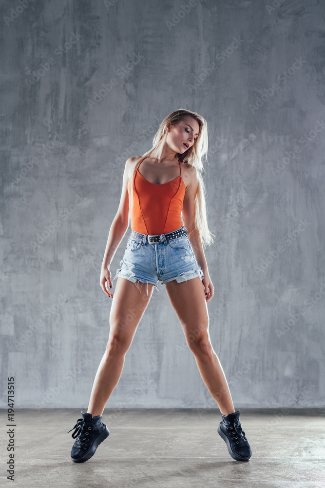 Young beautiful female dancer is posing in the studio Young beautiful female dancer is posing in the studio