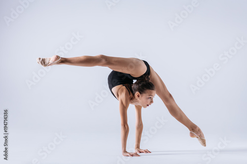 Young gymnast girl stretching and training