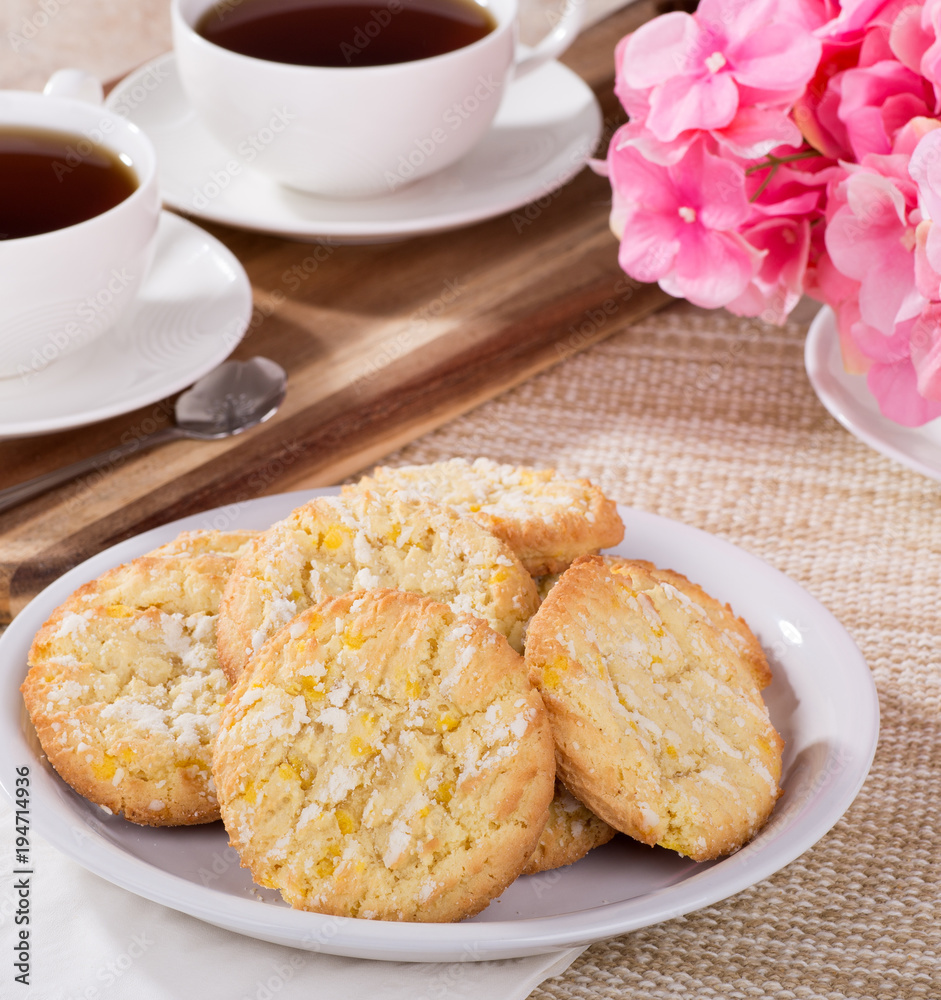 Pie of lemon crackle cookies on a plate and cups of coffee in background Pie of lemon crackle cookies on a plate and cups of coffee in background