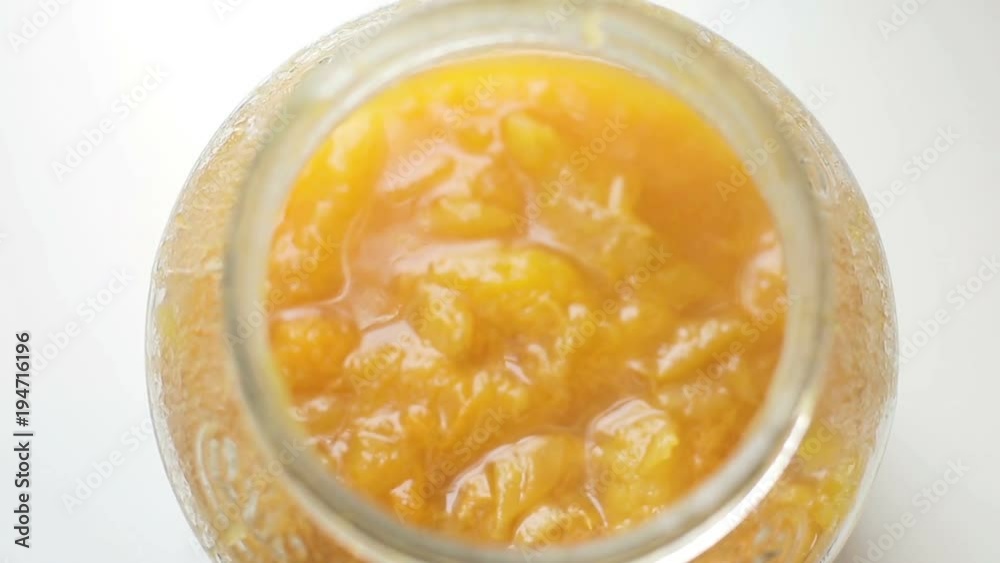 Homemade apricot jam of fresh organic apricots in a jar on a white background. Homemade apricot jam of fresh organic apricots in a jar on a white background.