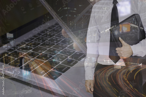 Double exposure of business man holding black leather file with laptop and hand holing mobile phone and lighting of road and building.