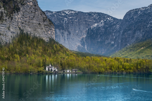 A beautiful castle with mountains in the background on the shores of the pristine Hallstatter lake near Hallstatt in Austria