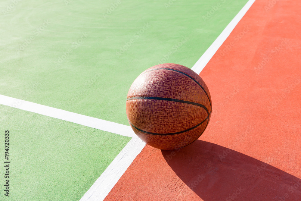 basketball on an outdoor playing field in a day time close up basketball on an outdoor playing field in a day time close up