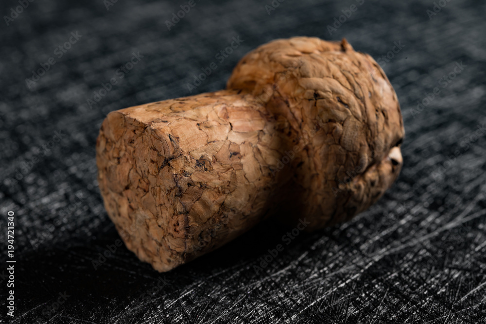 studio shoot of wooden cork from champagne bottle on a dark backrgound