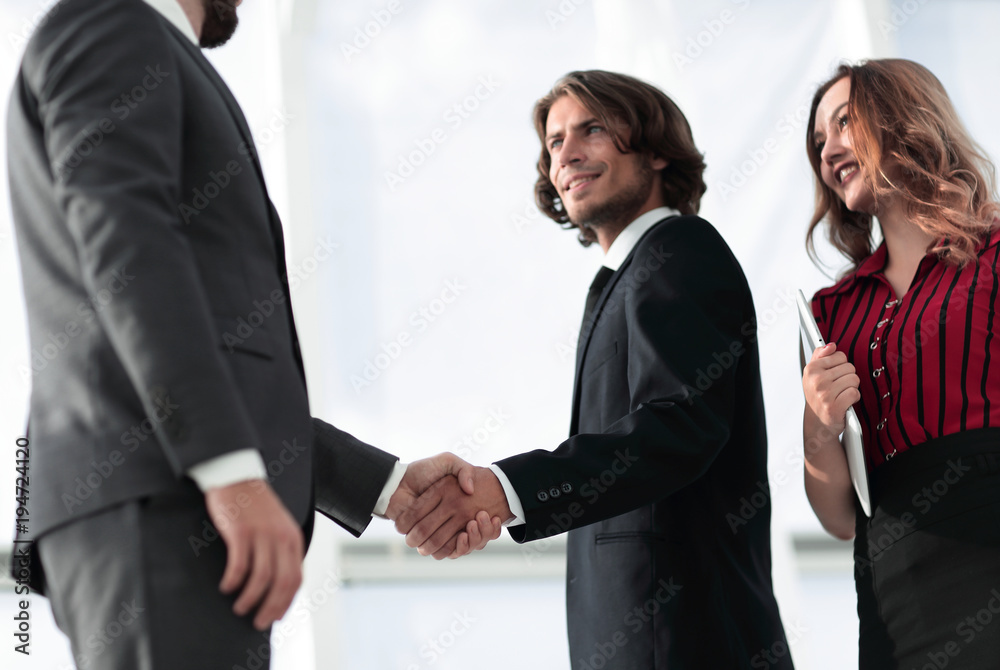 Young businessman shaking hands after agree to collaborate. Young businessman shaking hands after agree to collaborate.
