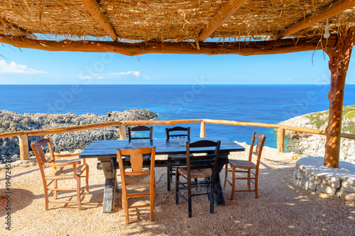 Table and chairs in traditional Greek tavern with view of beautiful Ionian sea. Zakynthos. Zante  Greece