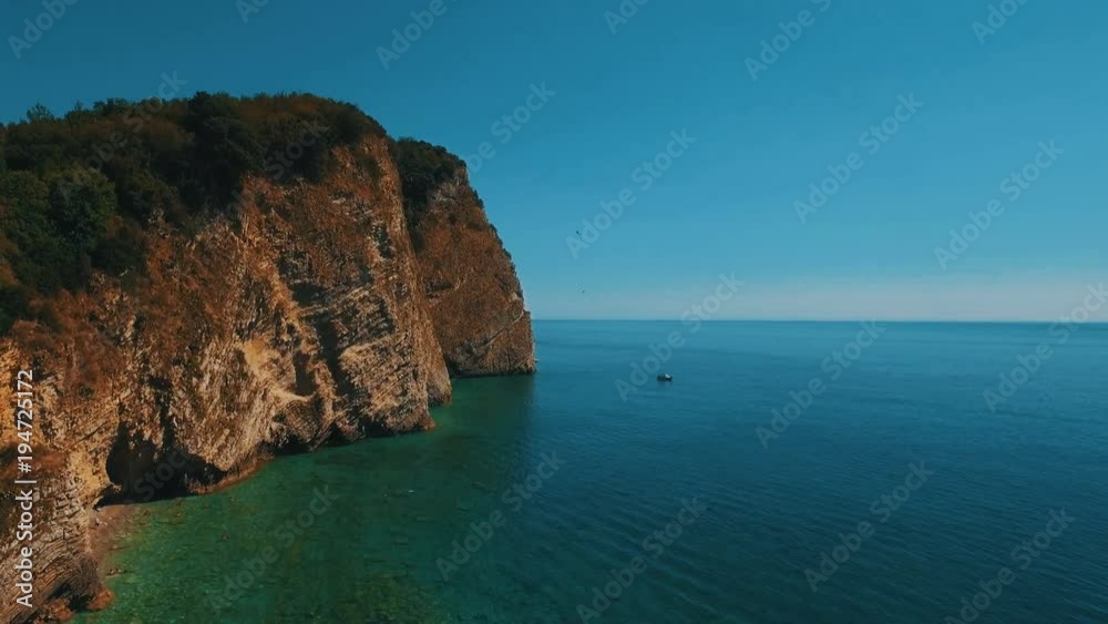 Aerial shot of sea waves and cliff. Sveti Nikola Island rock coast drone footage Aerial shot of sea waves and cliff. Sveti Nikola Island rock coast drone footage