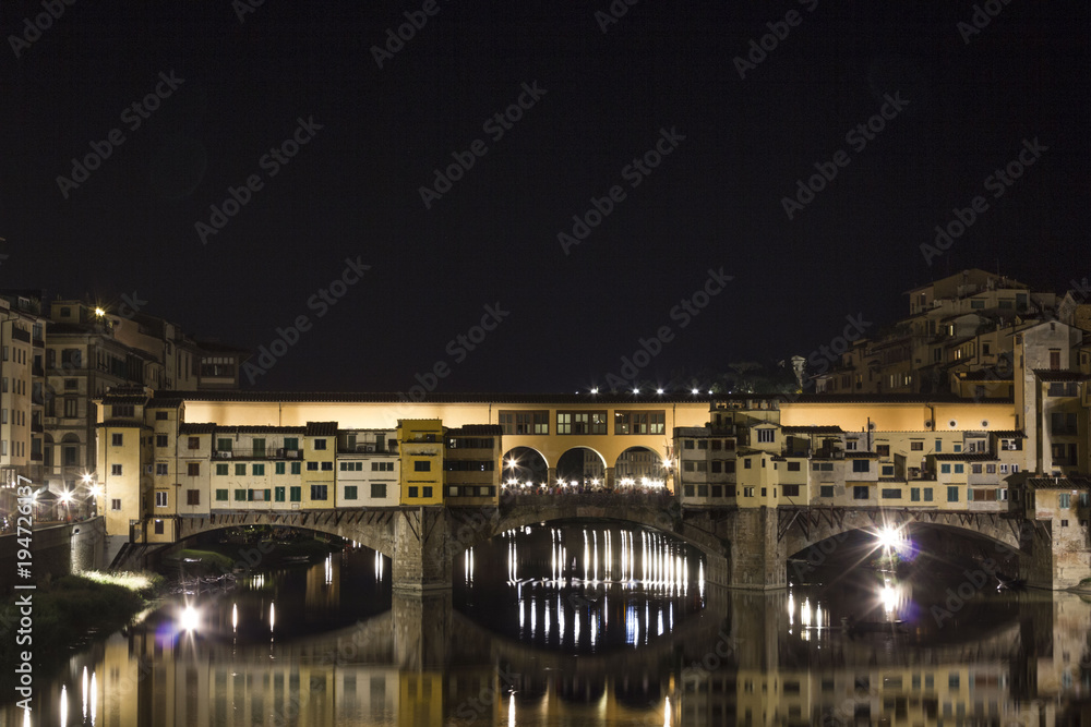 Night view of the historic Ponte Vecchio bridge in Florence on Arno river