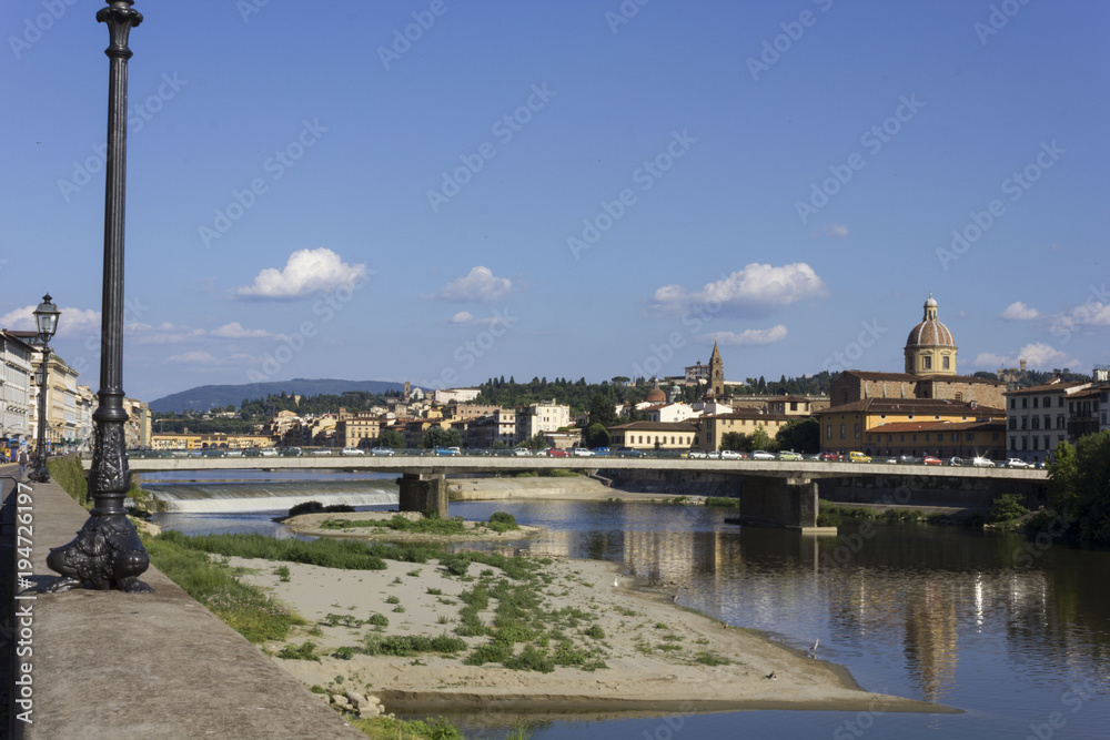 Florence cityscape at day time in summer season, with Amerigo Vespucci bridge in the foreground