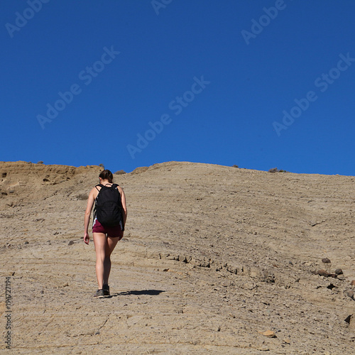 Upwards. Young woman on her way to the top of a mountain of volcanic origin, El Medano, Tenerife © Ines Porada