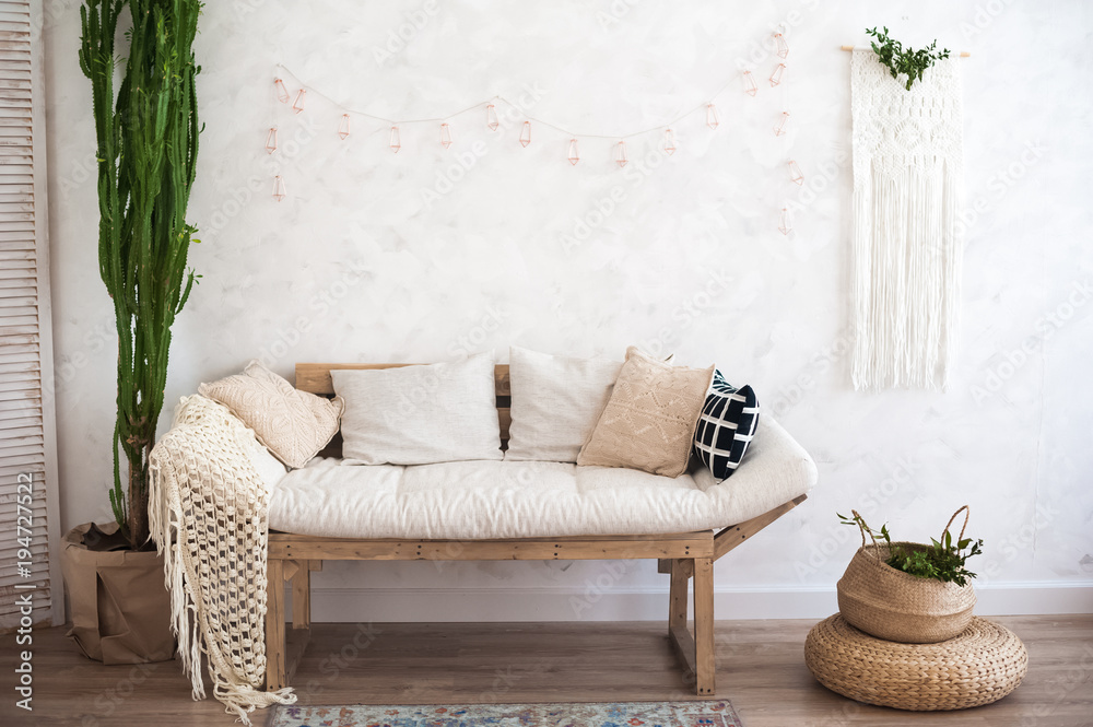 Beautiful spring decorated interior in white textured colors. Living room,  beige sofa with a rug and a large cactus. Stock Photo | Adobe Stock
