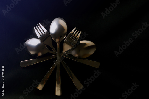 Spoons and forks. Black texture