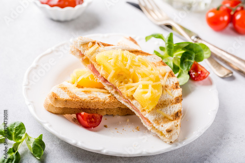 Hot fresh hawaii toast sandwich with ham, pineapple, tomato and cheese. Healthy summer food concept.