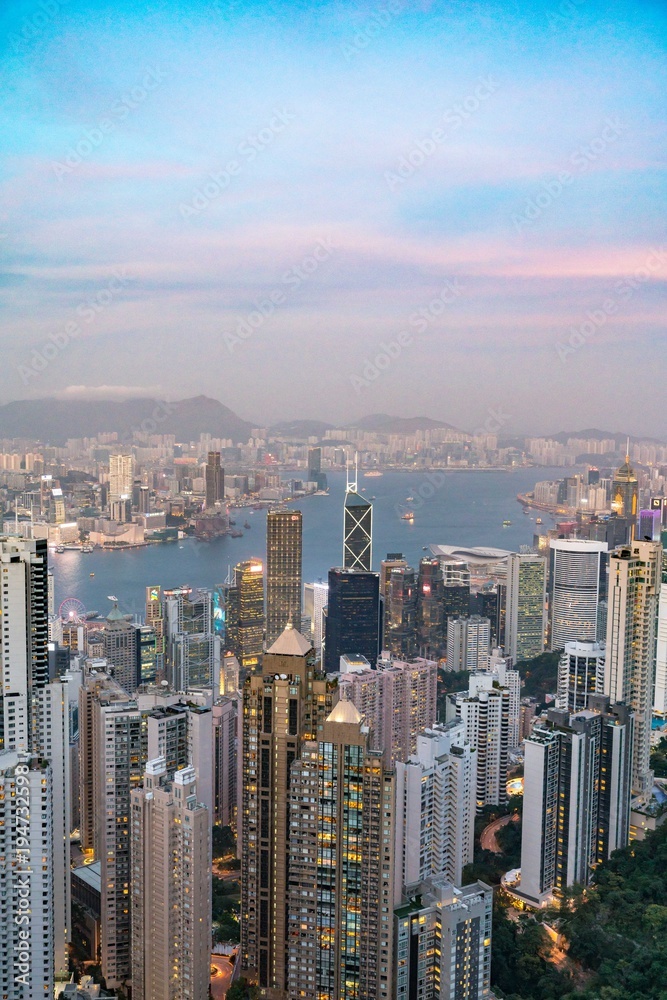 Naklejka premium Hong Kong tower on sundown bird eye view from kowloon at victoria peak tower the famous view point of hongkong