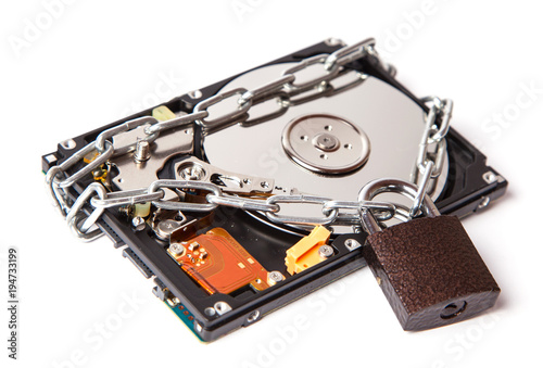 The information is password protected. The hard drive is wrapped around the chain with the lock locked. Isolated on white background