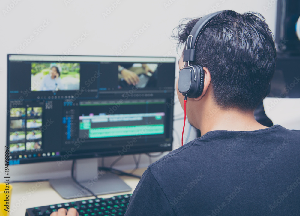 back view of video editor using computer back view of video editor using computer