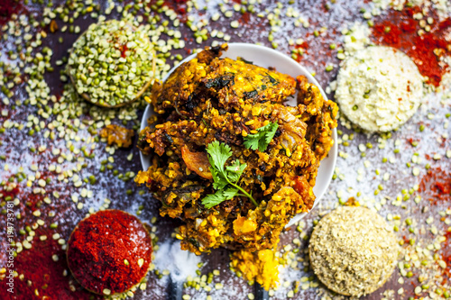 Close up of Indian/Asian popular Ramzan's/Ramadan's special vada/vadiya with all its grams,speices on a wooden surface in dark Gothic colors. photo