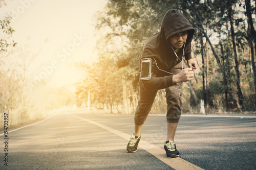 Man running on the road for health, color of vintage tone selective and soft focus