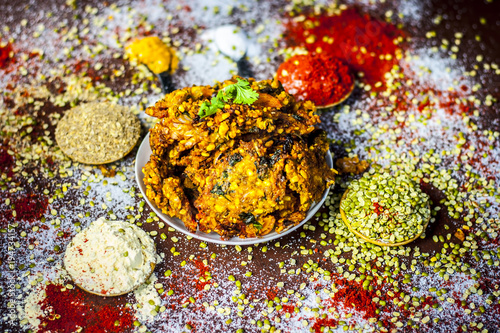 Close up of Indian/Asian popular Ramzan's/Ramadan's special vada/vadiya with all its grams,speices on a wooden surface in dark Gothic colors. photo