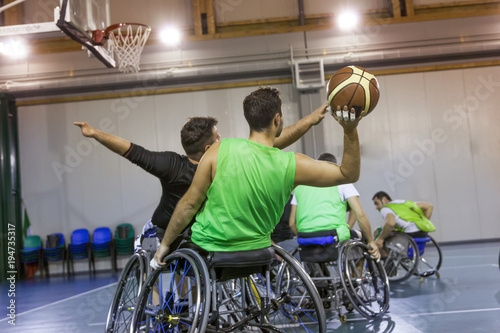 disabled sport men in action while playing indoor basketball