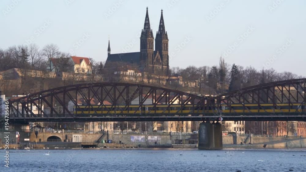 A view of Prague's castle Visehrad and the Vltava river on a winter day. Train pass over a bridge A view of Prague's castle Visehrad and the Vltava river on a winter day. Train pass over a bridge
