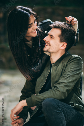 Spring photo session of a beautiful young couple in the old courtyards of the city.