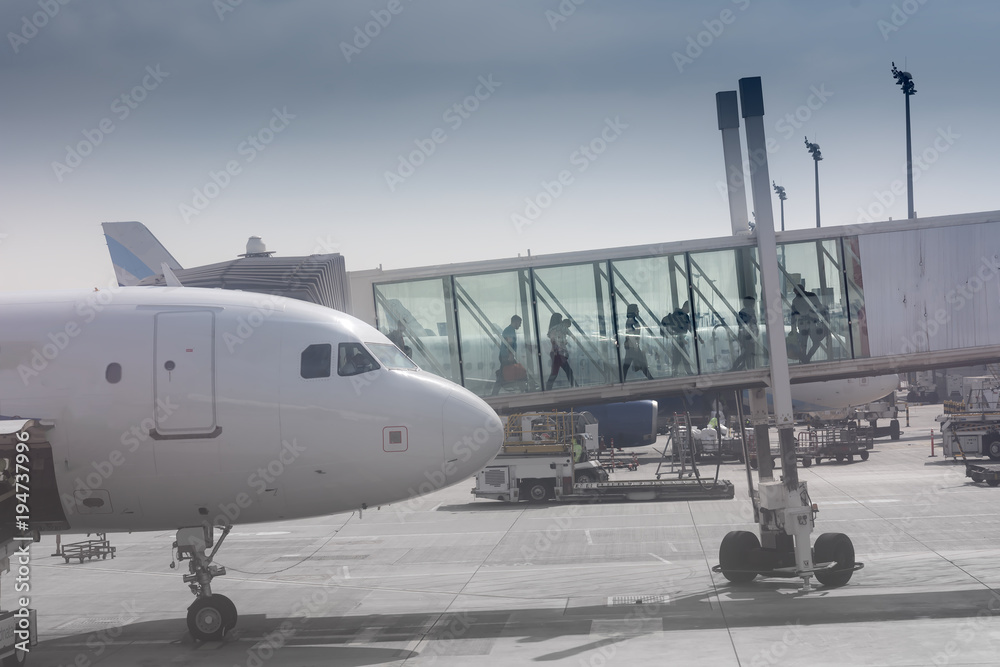 Fototapeta premium Passenger wide-body plane go through the bridge to the airport