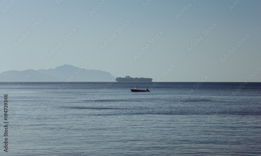 Egypt panoramic view os Red sea and Tiran island taken from Sharks Bay in Sharm el Sheikh with blue sky and water at summer evening