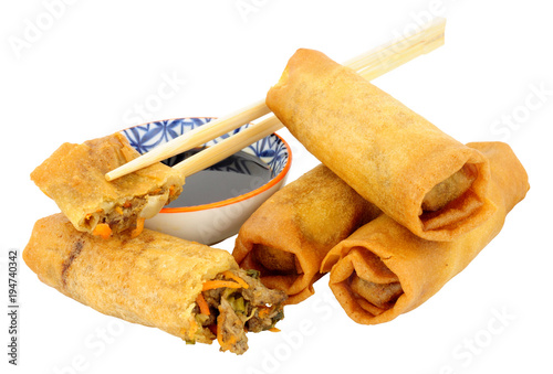 Chinese crispy duck filled spring rolls with soy sauce dip isolated on a white background