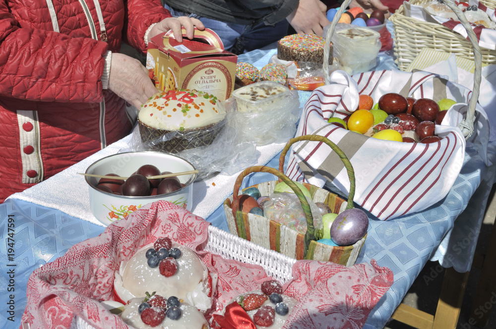 Fototapeta premium Baskets containing a sampling of Easter foods on the table, at the yard of Eastern Orthodox temple, to be blessed on Holy Saturday.