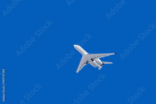 White Plane with Landing Gear in the Sky