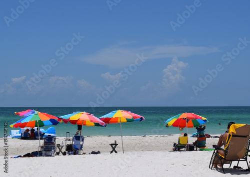 Beach with colorful umbrellas on a sunny day in Florida © Rebecca