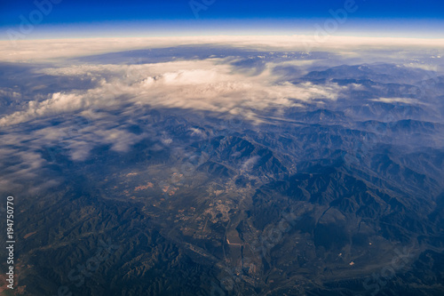 view from the window of the aircraft on the clouds and mountains